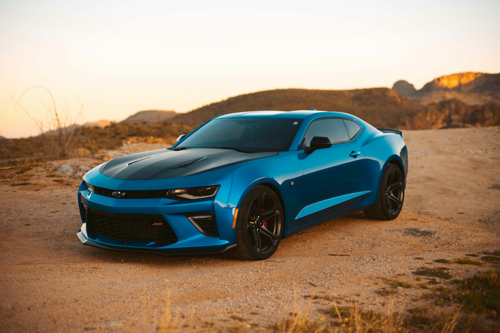 Blue sports car parked on the street in daylight