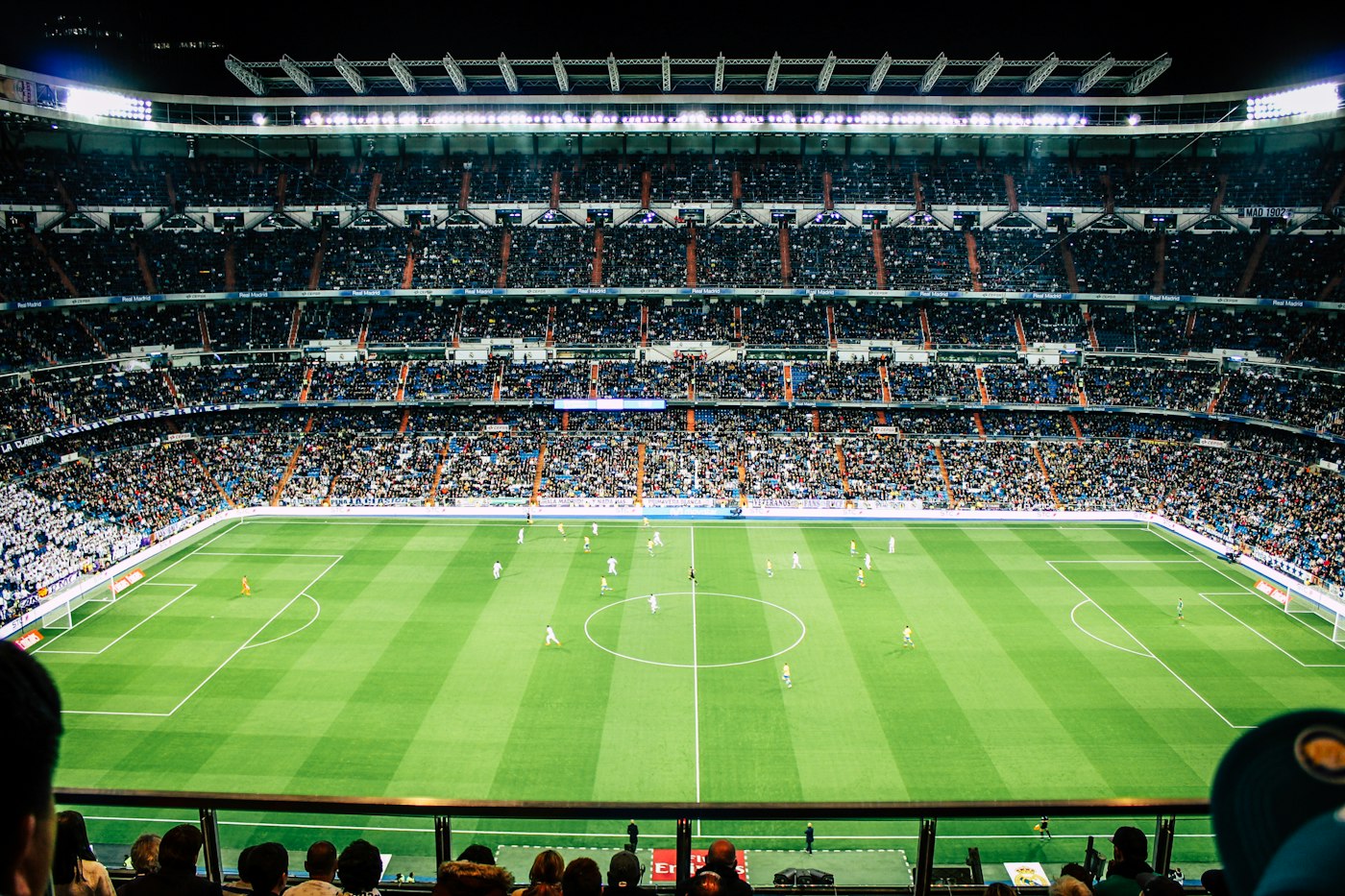 Stadium glowing under floodlights at night